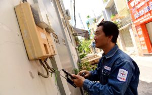 Nhân viên Công ty điện lực Tân Bình, TP.HCM Nguyễn Chí Cường ghi số điện trên đường Bàu Cát, Q. Tân Bình, TP.HCM trưa 22-4 - Ảnh: QUANG ĐỊNH