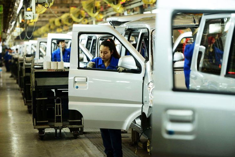 Công nhân làm việc tại một nhà máy sản xuất ôtô của GM tại Trung Quốc. Ảnh: AFP.