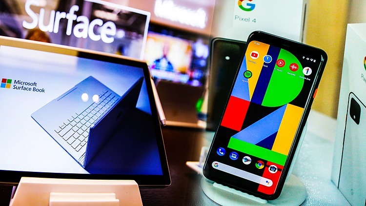 Một mẫu laptop Surface của Microsoft và một mẫu điện thoại Pixel của Google. Ảnh: Reuters