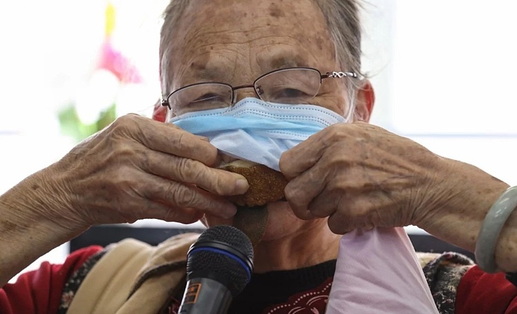 Lau Choi-yu nhét vỏ trái cây bên dưới khẩu trang để tái sử dụng nhiều lần. Ảnh: Nora Tam/SCMP.