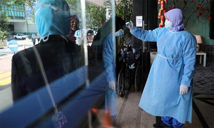 Y tá đo thân nhiệt để phát hiện người có triệu chứng nhiễm nCoV tại một bệnh viện tại thủ đô Kuala Lumpur, Malaysia ngày 3/2. Ảnh: Reuters.