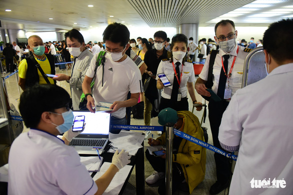 Xếp hàng chờ khai, nộp thông tin khai báo y tế ở sân bay Tân Sơn Nhất - Ảnh 4.