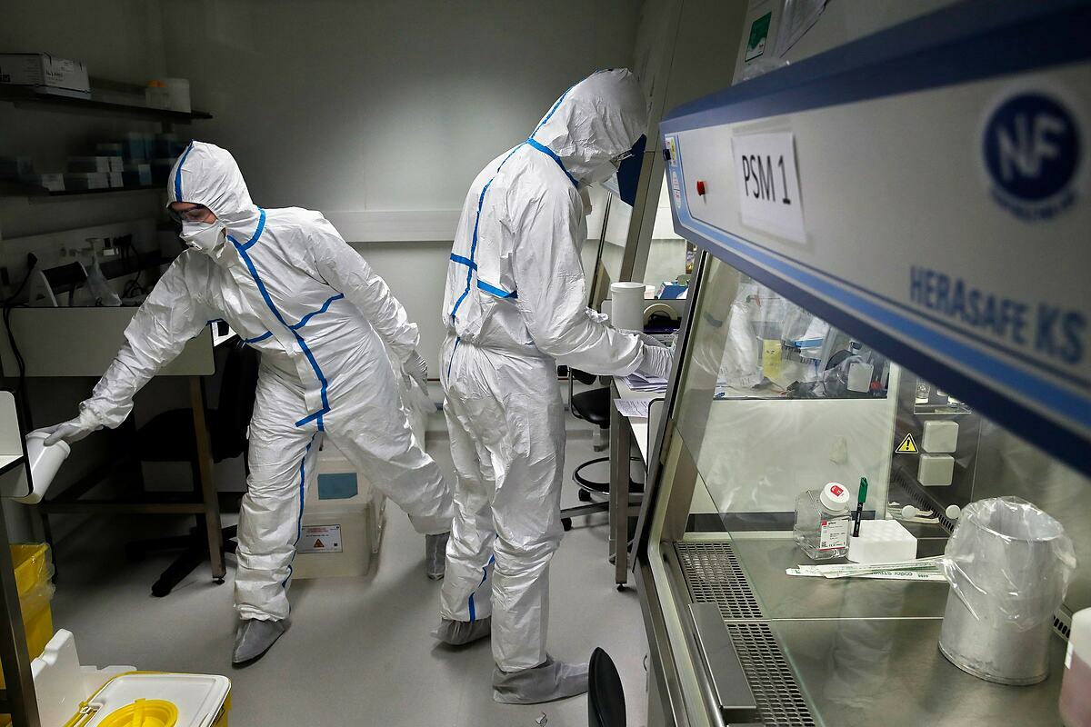 Các chuyên gia tại một phòng thí nghiệm Pháp đang kiểm tra mẫu bệnh phẩm của những ca nghi nhiễm Covid-19. Ảnh: AP