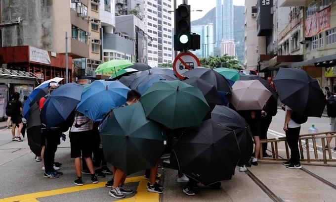 Người biểu tình phản đối dự luật an ninh Hong Kong dùng ô tạo thành rào chắn trên đường phố của đặc khu ngày 24/5. Ảnh: Reuters.