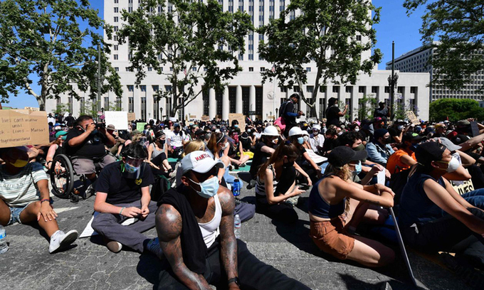 Người biểu tình ngồi bên ngoài trụ sở cơ quan công tố ở Los Angeles, hôm 3/6. Ảnh:AFP.