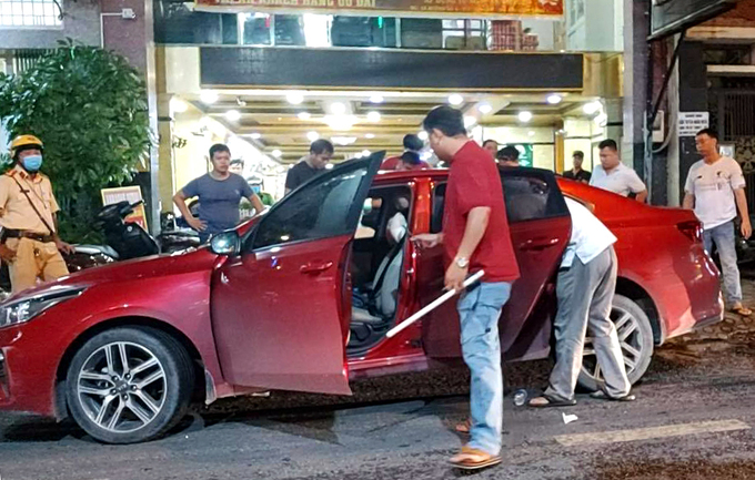 Cảnh sát khám xét chiếc xe do một nhóm để lại. Ảnh: Đình Văn.