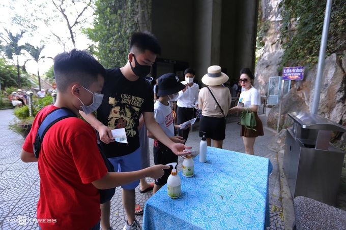 Du khách rửa tay sát khuẩn trước khi vào tham quan danh thắng Ngũ Hành Sơn, Đà Nẵng ngày 25/7/2020. Ảnh: Đắc Thành